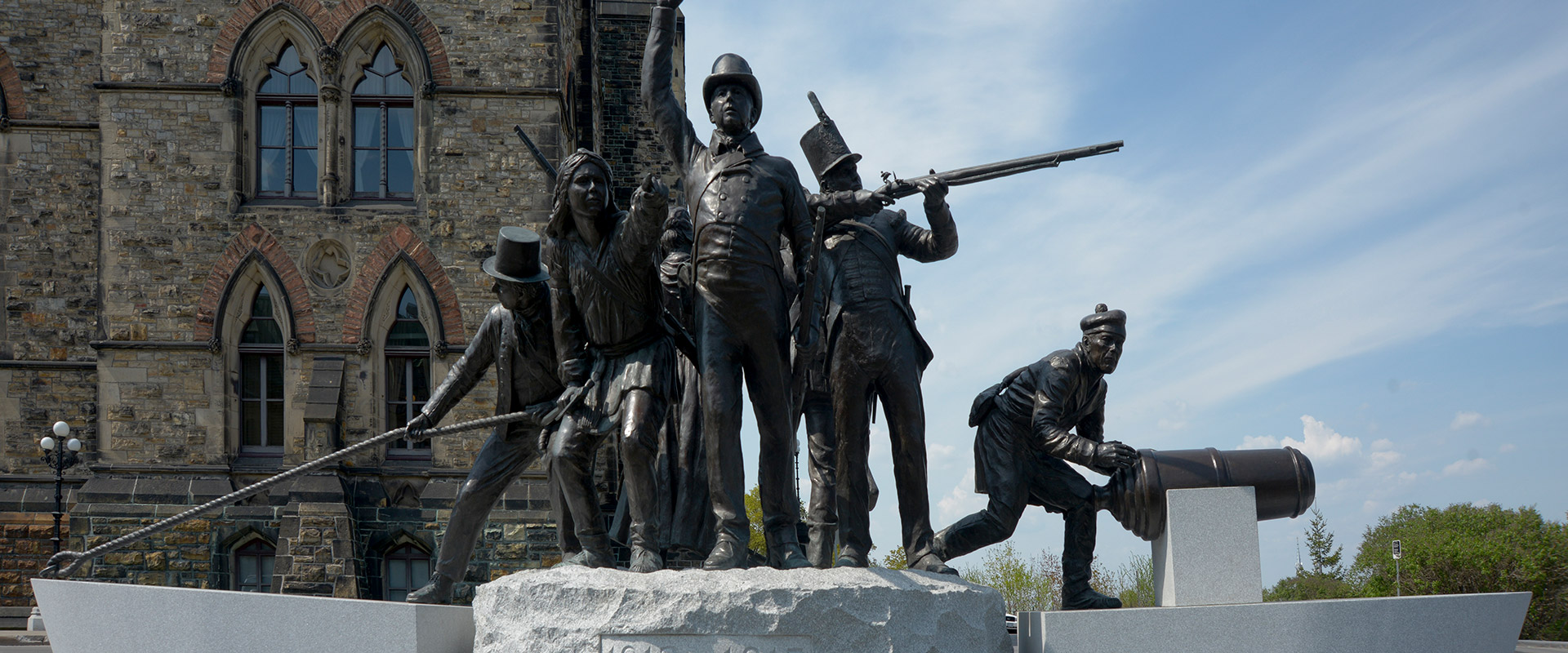 Soldiers poised for action atop a granite slab at the Triumph through Diversity War of 1812 Memorial