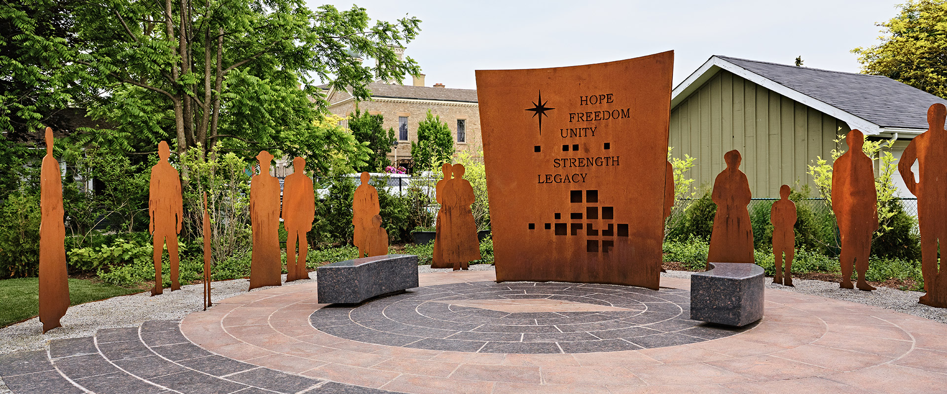 Granite slabs with silhouette cutouts at the Voices of Freedom Memorial in Niagara-on-the-Lake