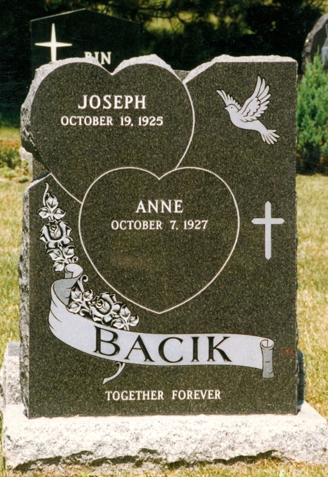 A black granite memorial with shape carved roses