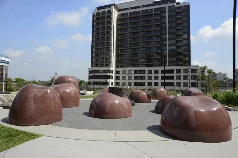 Giant red granite apples art installation