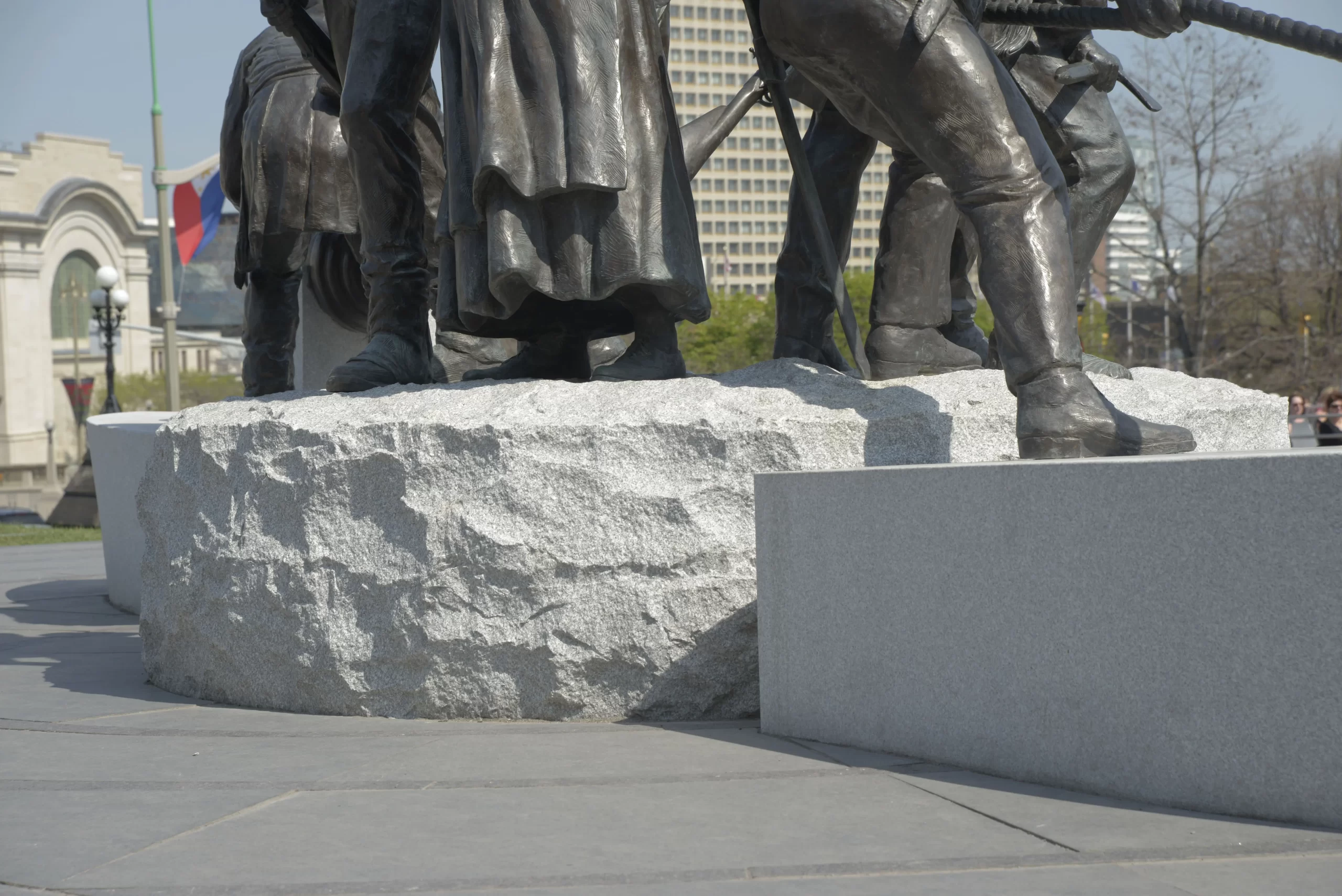 Close up of a grey public granite statue base