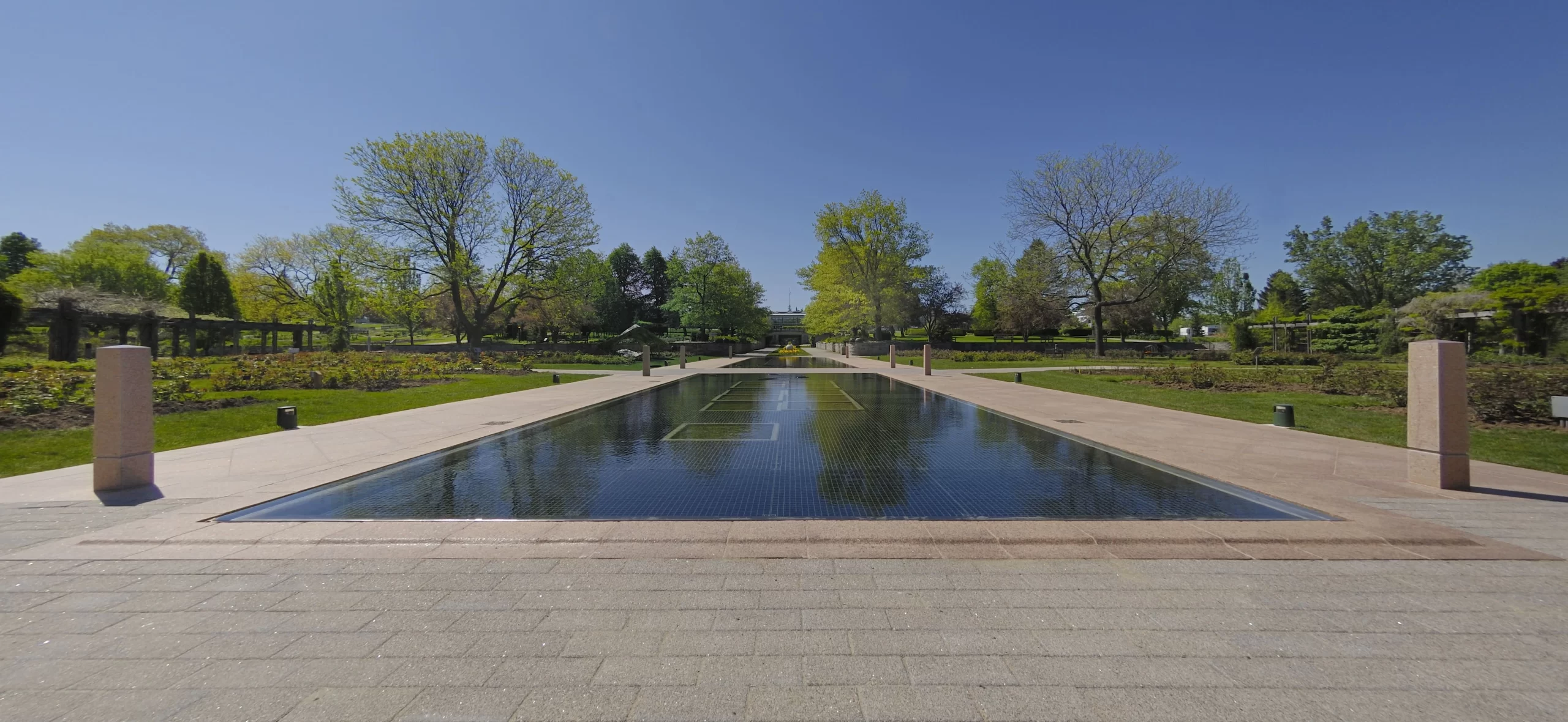 Granite bollards around a reflecting pond